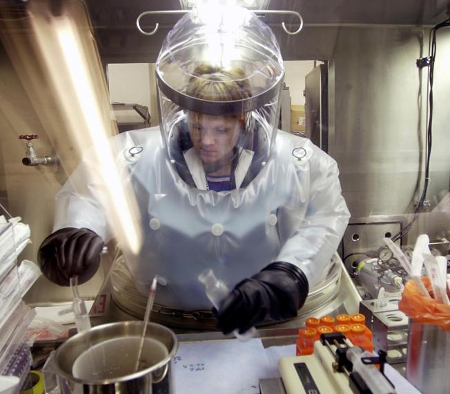 Microbiologist Ruth Bryan works with BG nerve agent simulant in Class III Glove Box in the Life Sciences Test Facility at Dugway Proving Ground, Utah. (AP Photo/Douglas C. Pizac) 