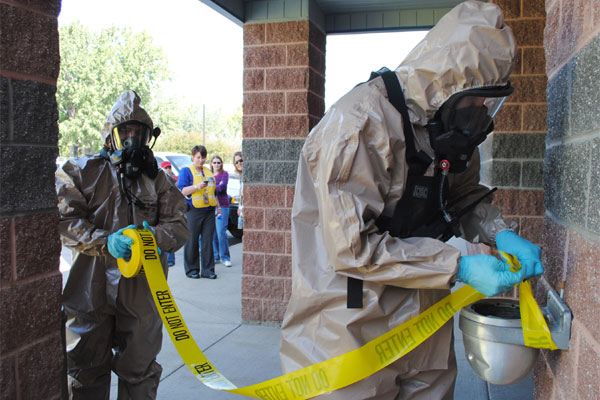 Two airmen set up security at the contamination site during a Bio-Detection System exercise. (U.S. Air Force photo/Airman 1st Class Katrina Heikkinen)