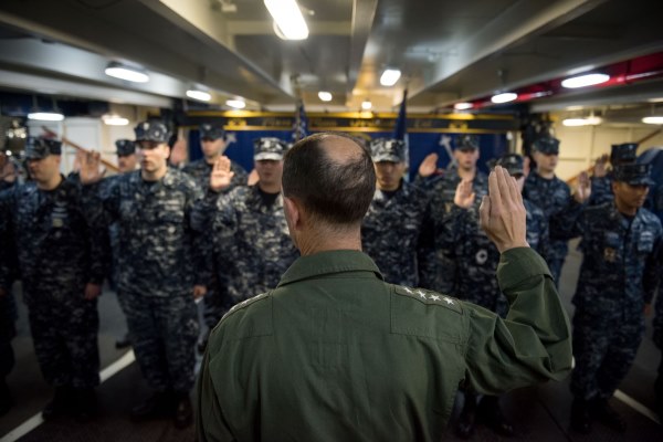 Chief of Naval Operations Navy Adm. John Richardson reenlists sailors aboard the USS John C. Stennis aircraft carrier, on June 5, 2016, in the South China Sea. (Photo by Kenneth Rodriguez Santiago/U.S. Navy)
